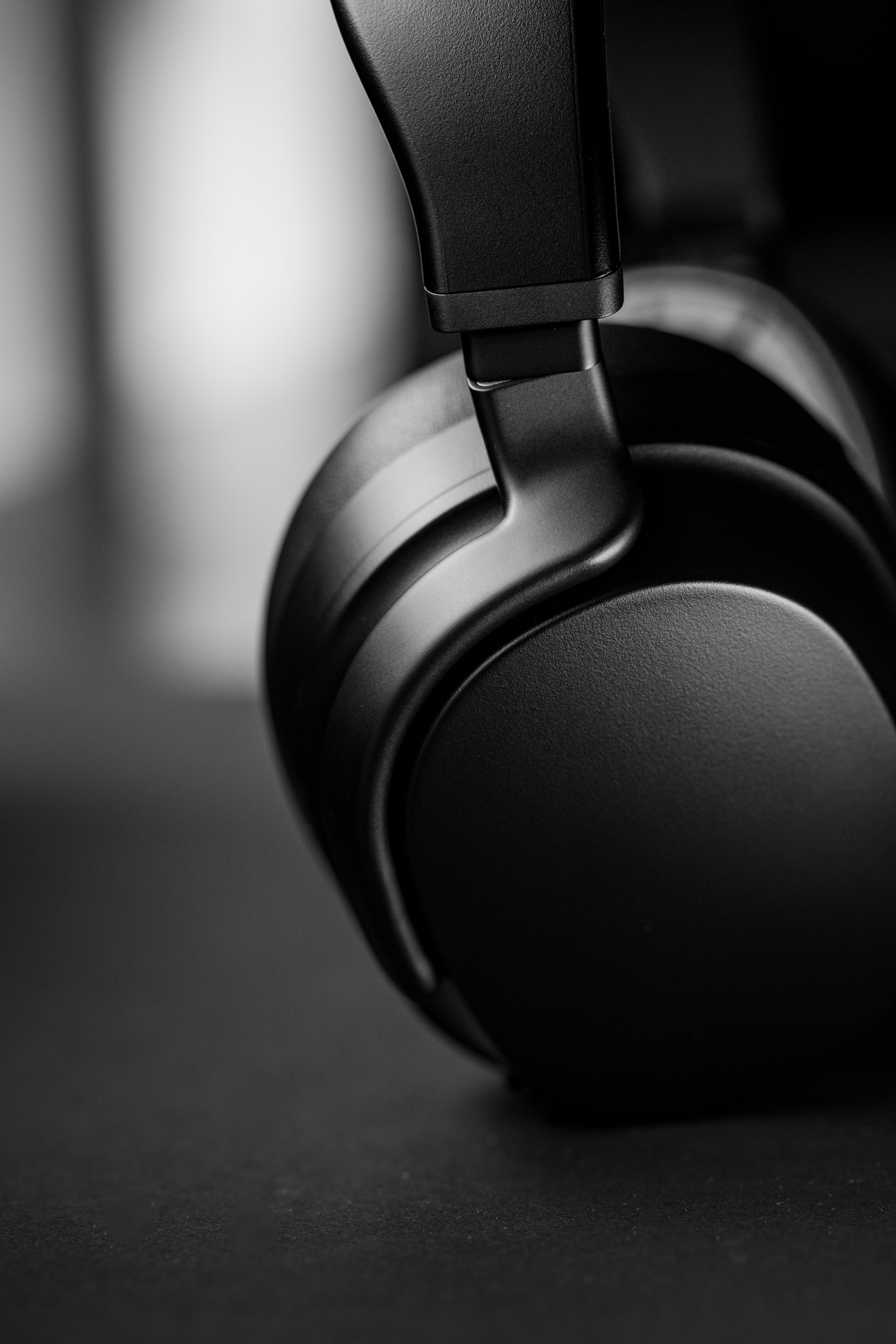 black and gray headphones on black and white surface